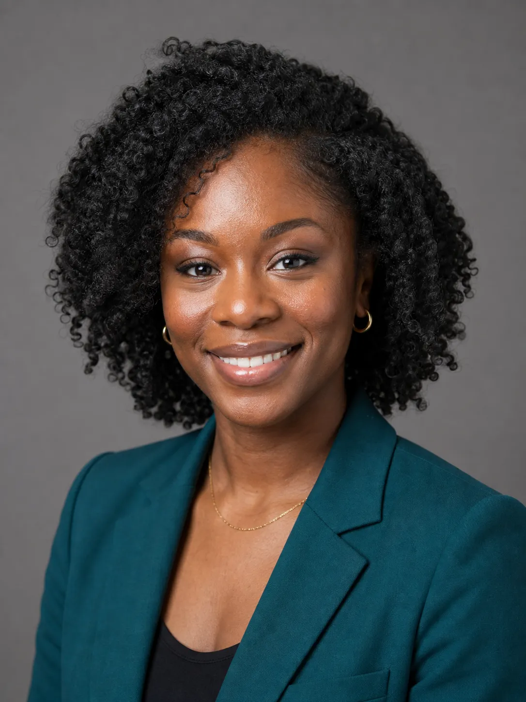 A clean headshot background swap, the same woman against a neutral mid-gray studio backdrop with a natural hair edge and lighting that matches her face, the corrected version that reads as a real studio photo.