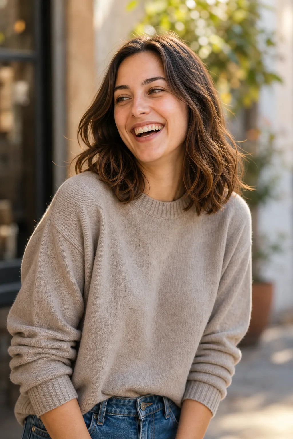 A woman caught mid-laugh looking away from the camera, a genuinely candid photo that does not look posed.