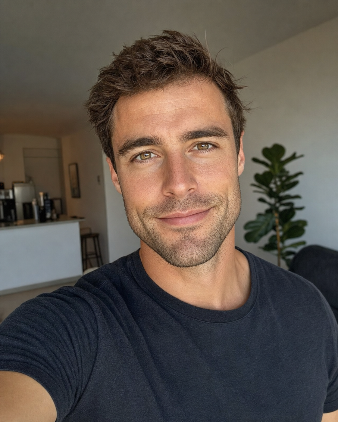 A photoreal 4:5 vertical dating-app lead photo of the same 32-year-old man holding his phone at eye level in soft natural window light with a real warm half-smile and direct eye contact, his face occupying about 60% of the vertical frame and his eyes landing on the upper-third grid line, framed mid-chest up in a plain charcoal tee with a softly-blurred living-room interior behind.